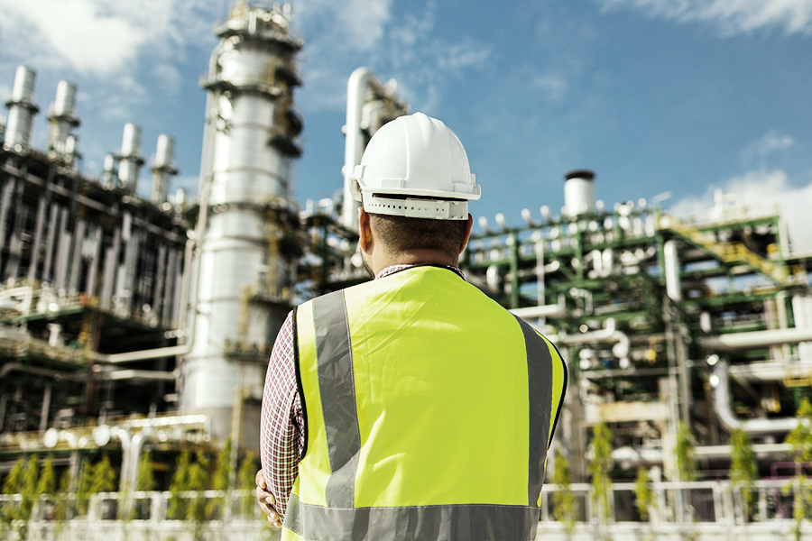 oil & gas supply chain employee overlooking safety procedures at the refinery